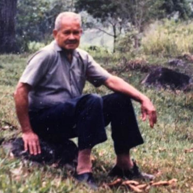 This image shows the Colombian Coffee farmer himself  Don Jose himself sitting on a rock in his coffee farm based in salazar colombia