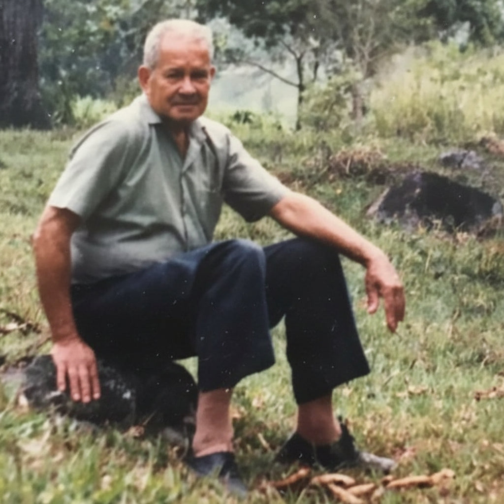 This image shows the Colombian Coffee farmer himself  Don Jose himself sitting on a rock in his coffee farm based in salazar colombia